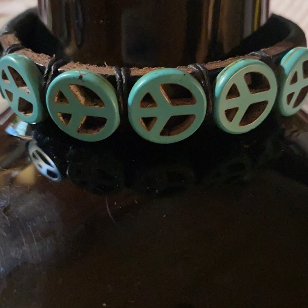 Leather wrap bracelet with hand carved turquoise peace charms
